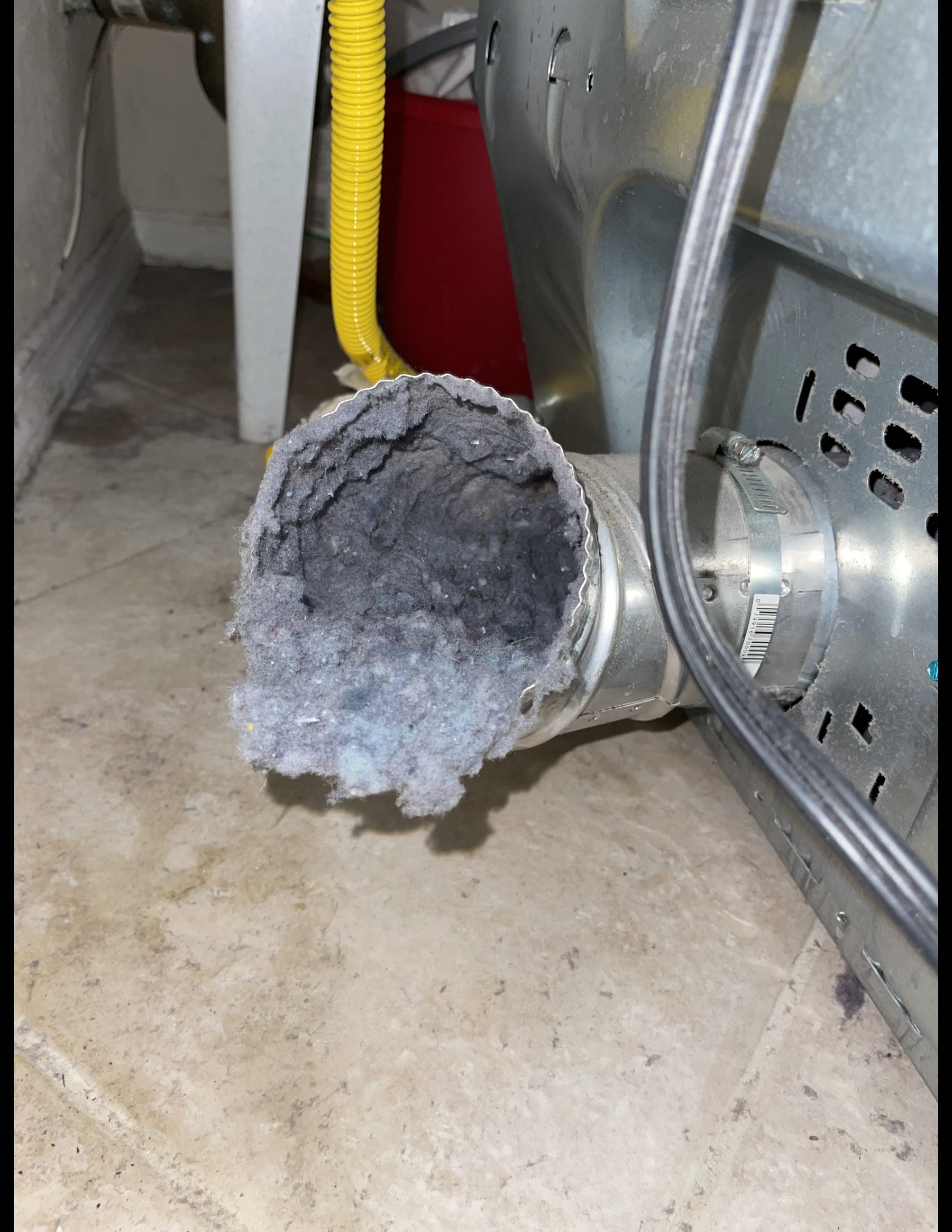 Lint buildup blocking a dryer vent connection