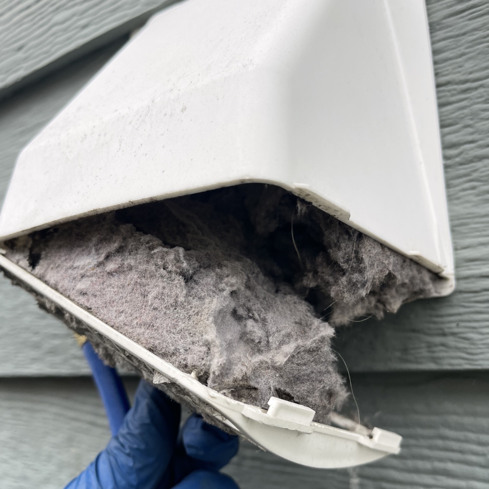 Dryer lint clogging an exterior vent cover